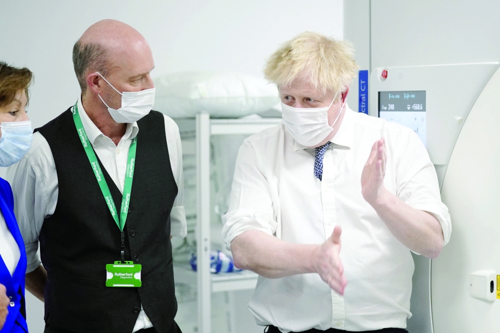 Prime Minister Boris Johnson, wearing a face covering to help mitigate the spread of Covid-19, reacts during a visit to the Rutherford Diagnostic Centre in Taunton, south west England on Thursday. - AFP 