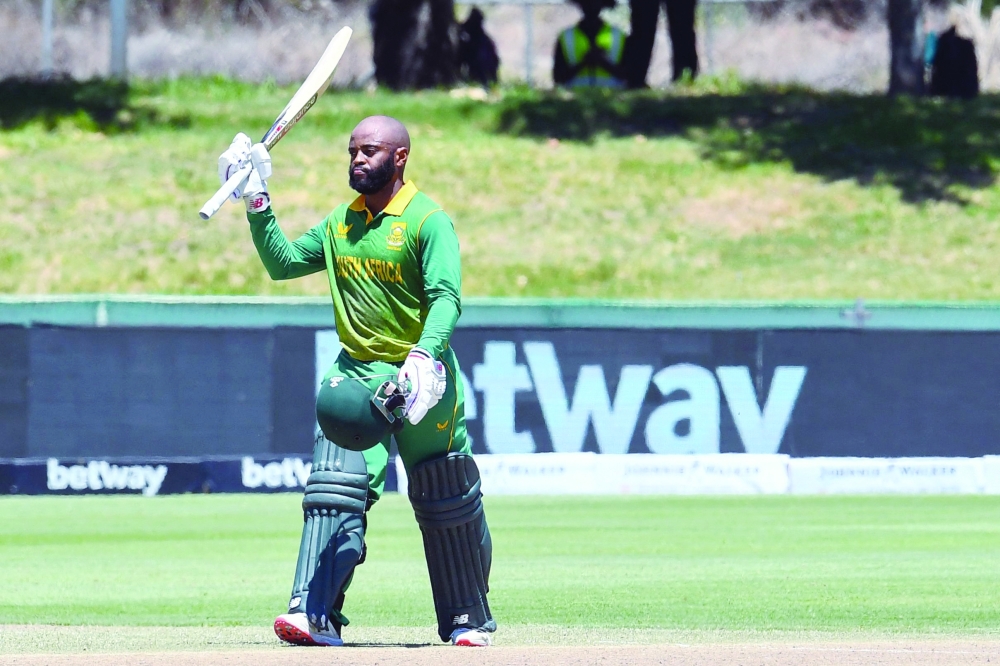 South Africa's Temba Bavuma celebrates after scoring a century (100 runs) during the first one-day international (ODI) cricket match between South Africa and India at Boland Park in Paarl on January 19, 2022. (Photo by RODGER BOSCH / AFP)

