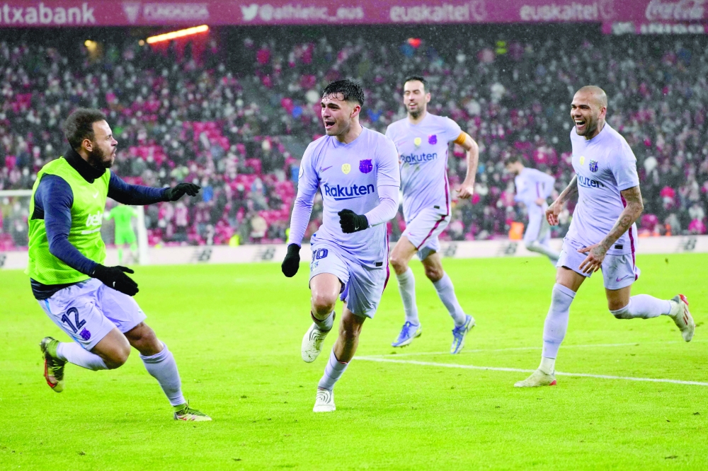 Barcelona's Spanish midfielder Pedri (C) celebrates after scoring a goal. -- AFP