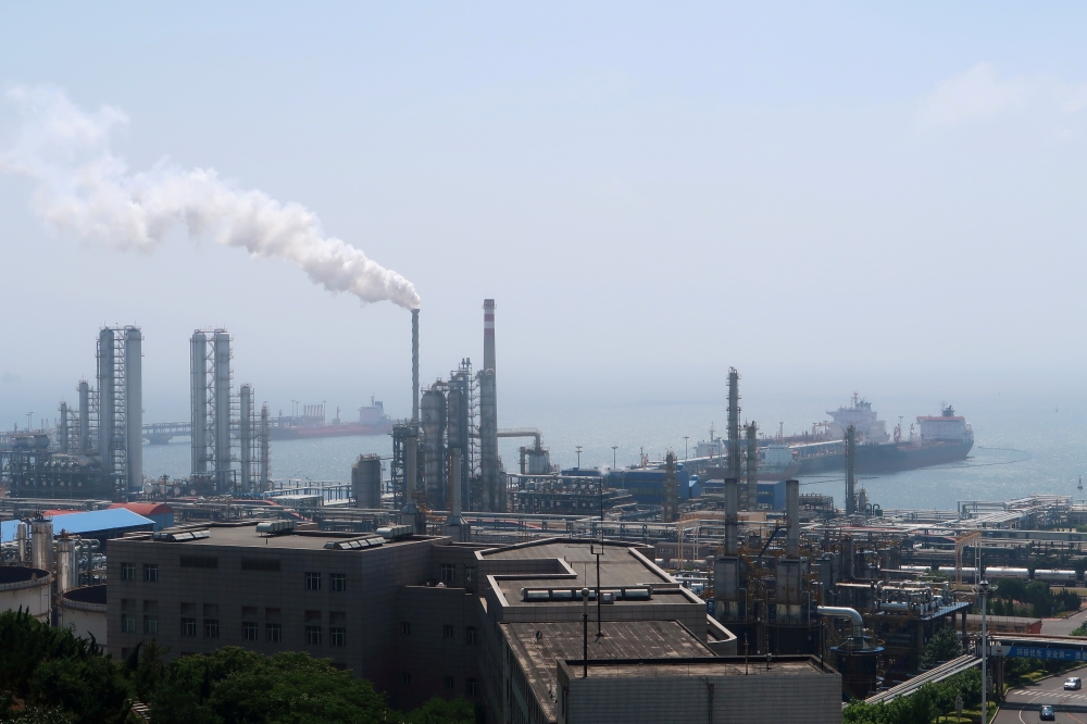 FILE PHOTO: China National Petroleum Corporation (CNPC)'s Dalian Petrochemical Corp refinery is seen near the downtown of Dalian