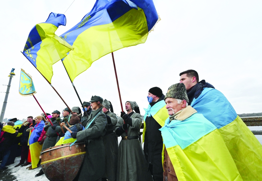 People form a symbolic human chain on a bridge across the Dnieper river in Kyiv, to mark the Day of Unity of Ukraine. - AFP 
