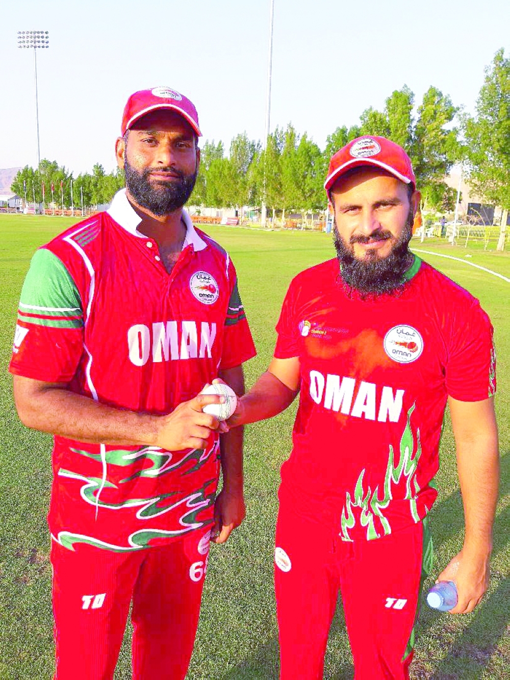 Hat-trick hero Khawar Ali with his captain Zeeshan Maqsood after Oman's win over Netherlands