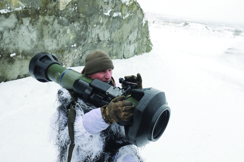 A Ukrainian Military Forces serviceman aims with a Next generation Light Anti-tank Weapon (NLAW) Swedish-British anti-aircraft missile launcher during a drill at the firing ground of the International Center for Peacekeeping and Security, near the western Ukrainian city of Lviv on Friday. - AFP