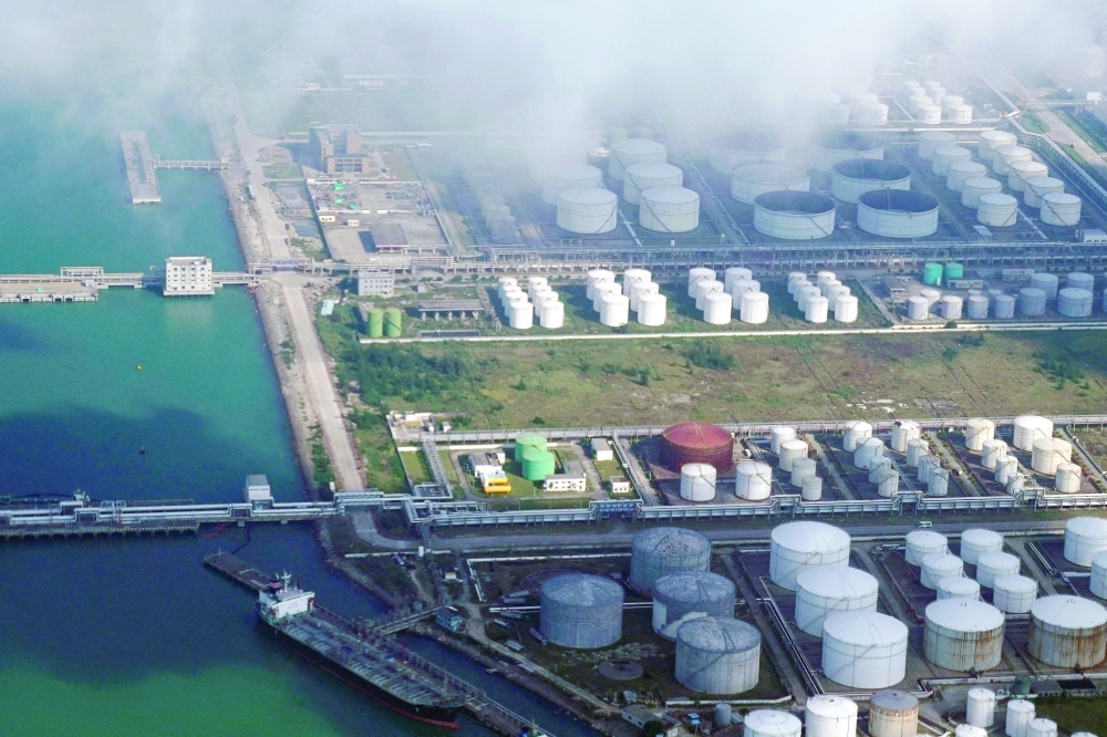 FILE PHOTO: Oil and gas tanks are seen at an oil warehouse at a port in Zhuhai