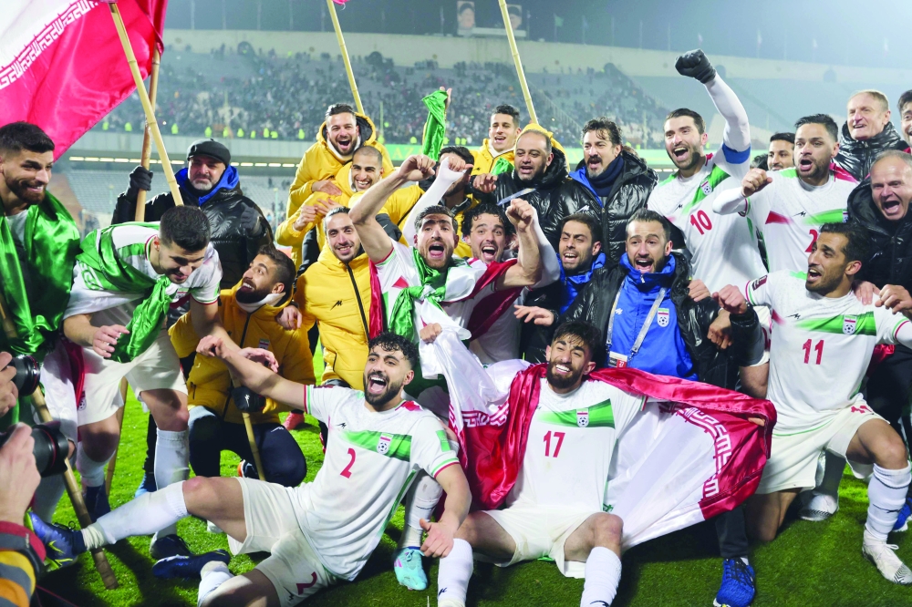 Iran's players celebrates qualifying for the 2022 Qatar World Cup after their win in the Asian Qualifiers match between Iran and Iraq, at the Azadi Sports Complex. -- AFP