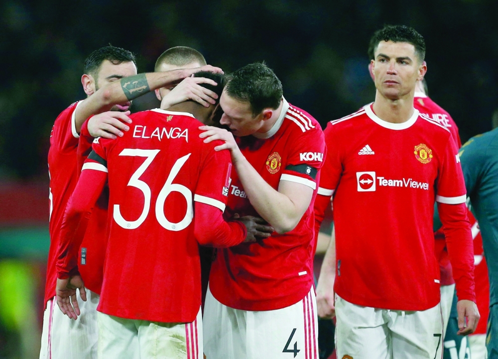 Manchester United's Anthony Elanga is consoled by teammates after missing his penalty during the shoot-out. -- Reuters