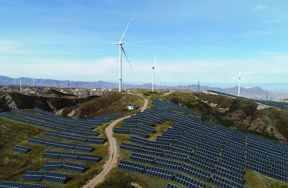 Wind turbines and solar panels are seen at a wind and solar power plant by State Power Investment Corporation (SPIC) in Zhangjiakou, Hebei province, China. — Reuters