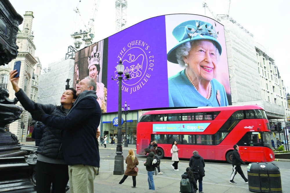 Images of Britain's Queen Elizabeth II are displayed on the big digital screens at Piccadilly Circus in central London to mark the start of Her Majesty's Platinum Jubilee Year. - AFP