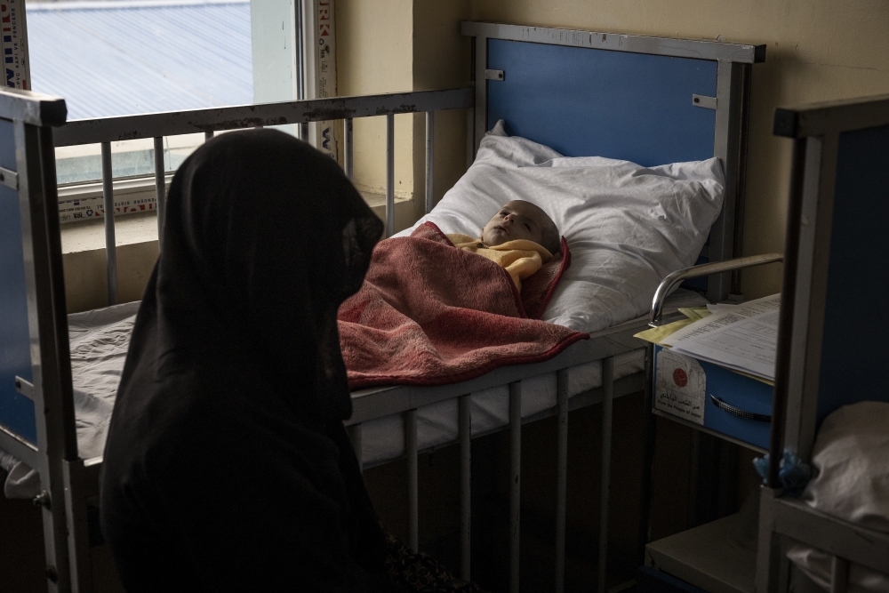 Women tending to recovering children at the malnutrition ward of the Indira Gandhi Children's Hospital in Kabul, Afghanistan, Jan. 12, 2022.  (Jim Huylebroek/The New York Times)
