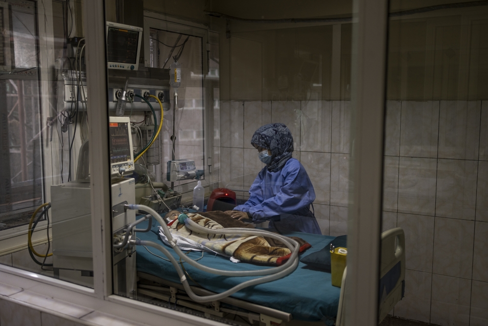 A nurse tends to a child at an intensive care unit for severe cases at the Indira Gandhi Children's Hospital in Kabul, Afghanistan, Jan. 12, 2022.  (Jim Huylebroek/The New York Times)