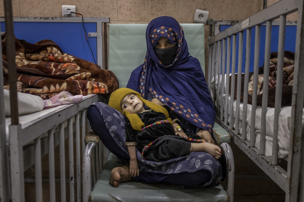 Soraya, 2, and her mother, Sara, 17, at the malnutrition ward at the Indira Gandhi Children's Hospital in Kabul, Afghanistan, Jan. 12, 2022.  (Jim Huylebroek/The New York Times)