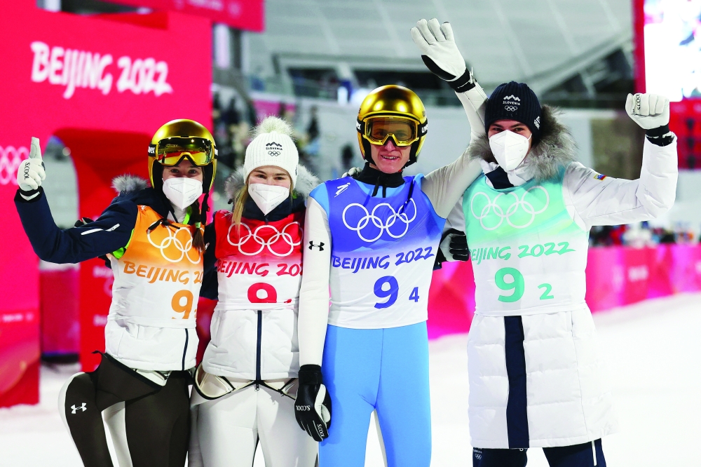 Nika Kriznar of Slovenia, Timi Zajc of Slovenia, Ursa Bogataj of Slovenia and Peter Prevc of Slovenia calebrate REUTERS/