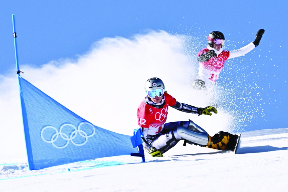 Czech Republic's Ester Ledecka (L) and Russia's Natalia Soboleva compete in the snowboard women's parallel giant slalom qualification run. -- AFP
