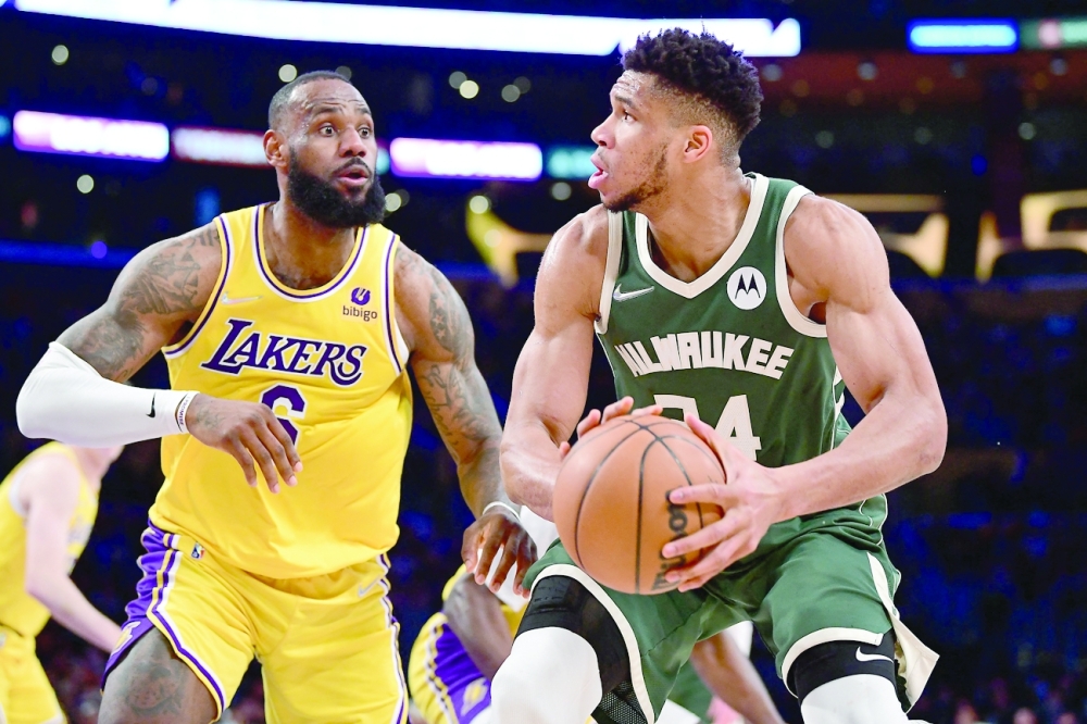 Milwaukee Bucks forward Giannis Antetokounmpo (34) moves the ball against Los Angeles Lakers forward LeBron James (6) during the second half at Crypto.com Arena. -- USA Today Sports
