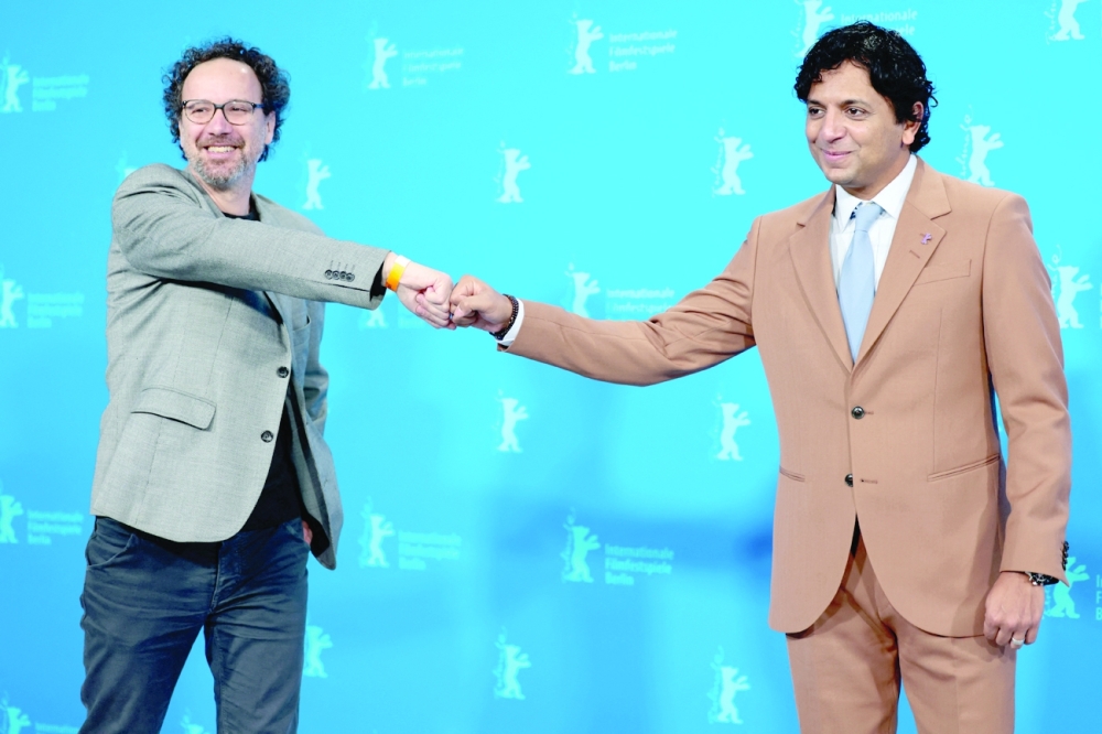 Carlo Chatrian, artistic director of the Berlinale and member of jury, M. Night Shyamalan pose for a photo during a photo call at the 72th Berlinale International Film Festival in Berlin on Thursday. — Reuters