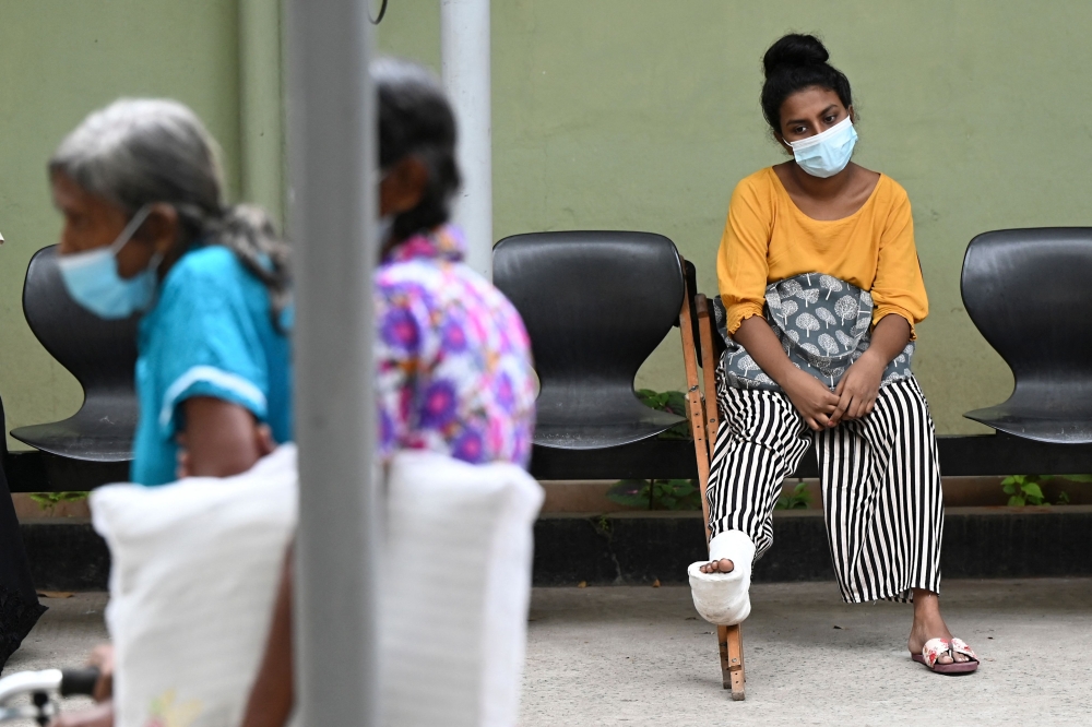 A patient waits for treatment at a hospital as health workers hold a work strike in Colombo on February 11, 2022.