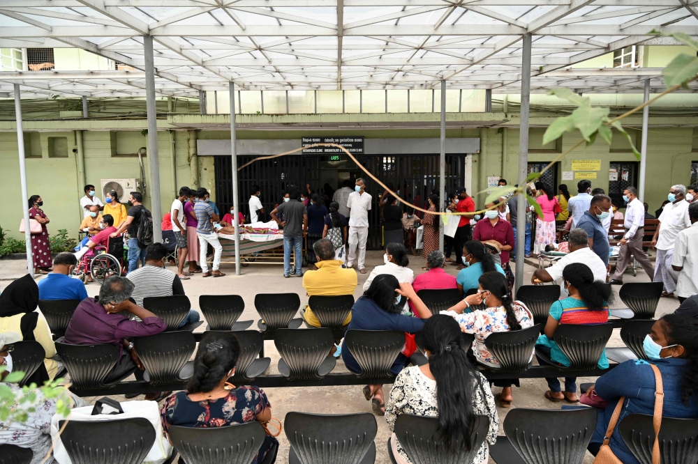 Patients wait for treatment at a hospital as health workers hold a work strike in Colombo on February 11, 2022