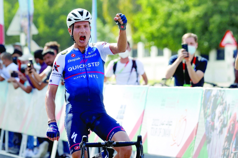 Quick-Step Alpha Vinyl Team's rider Fausto Masnada reacts as he wins the fourth stage of the Oman Tour between al-Sifah and Royal Opera House Muscat, in Muscat on February 13, 2022.  (Photo by Thomas SAMSON / AFP)

