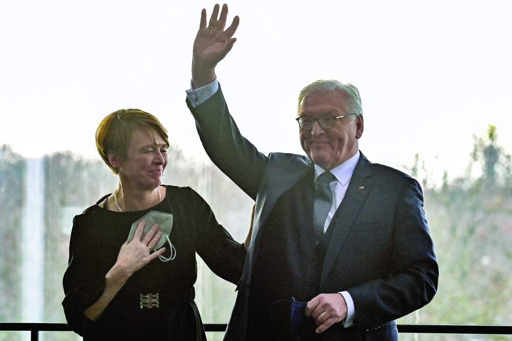 German President Frank-Walter Steinmeier waves next to his wife Elke Buedenbender after his re-election as Germany's President in Berlin. - Reuters
