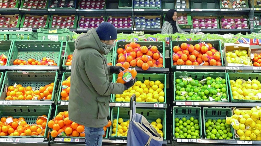 A man shops inside a supermarket in central London. — AFP