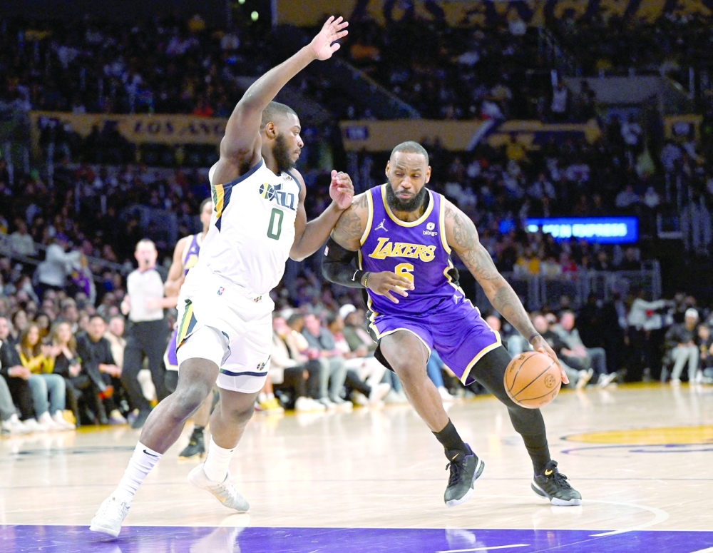 Los Angeles Lakers forward LeBron James (6) is defended by Utah Jazz forward Eric Paschall (0) in the first half at Crypto.com Arena. -- USA Today Sports
