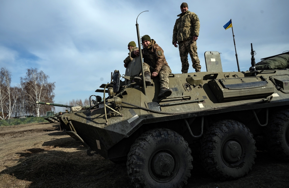 Ukrainian tank crews take a break during military exercises on Wednesday, Feb. 16, 2022 at a base near Rivne, about 60 miles from the Belarus border. (Lynsey Addario/The New York Times)