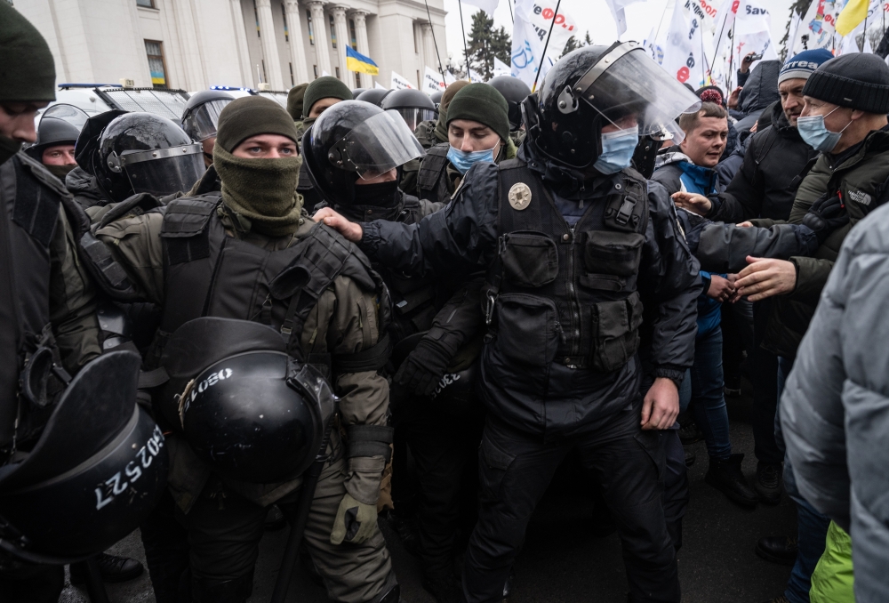 Police officers during clashes with supporters of the "save small business" movement outside the Ukrainian Parliament in Kyiv, Ukraine, Feb. 17, 2022.  (Lynsey Addario/The New York Times) 