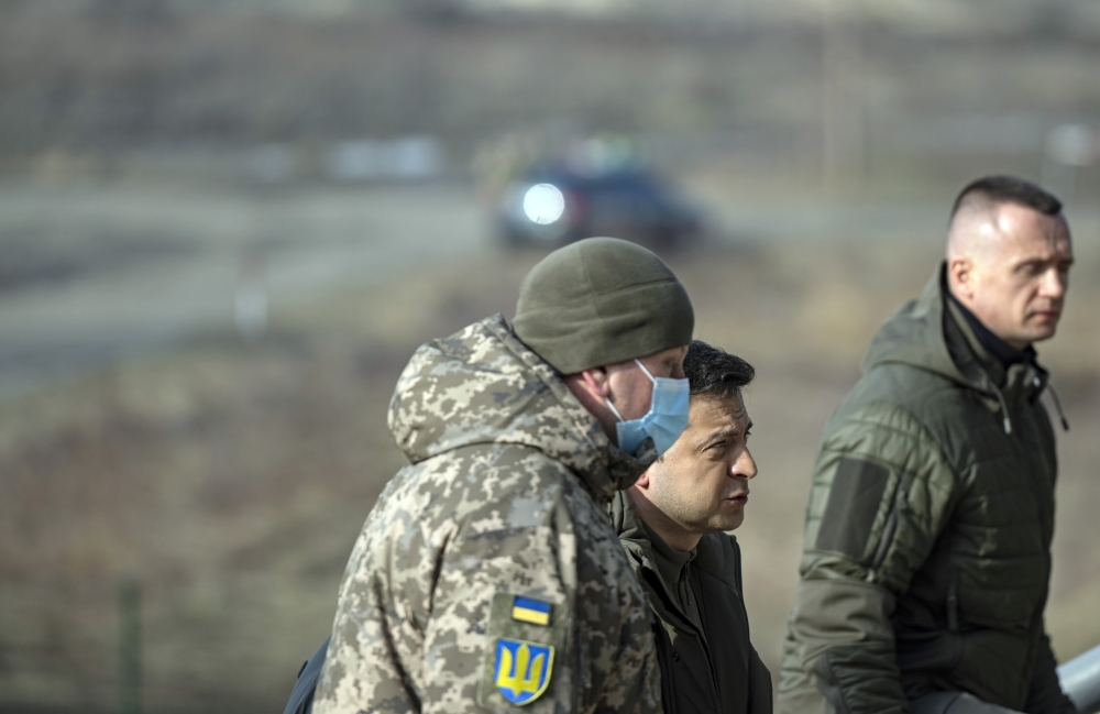 President Volodymyr Zelensky of Ukraine, second from left, arrives to attend military exercises on Wednesday, Feb. 16, 2022 at a base near Rivne, about 60 miles from the Belarus border.  (Lynsey Addario/The New York Times)