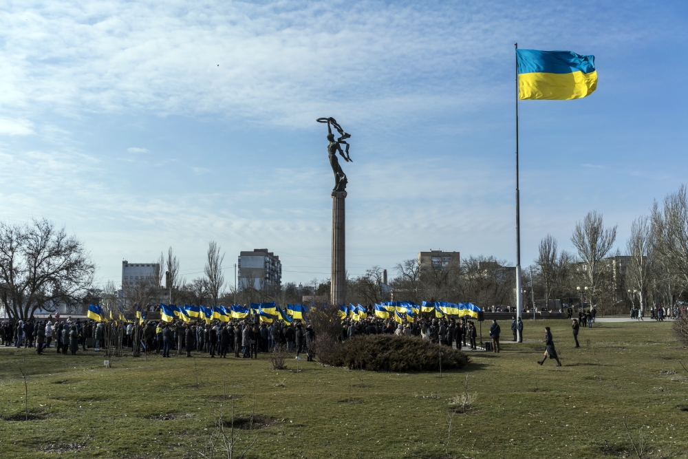 People gather for a ceremony to mark Unity Day in Kherson, Ukraine, on Wednesday, Feb. 16, 2022. (Brendan Hoffman/The New York Times)