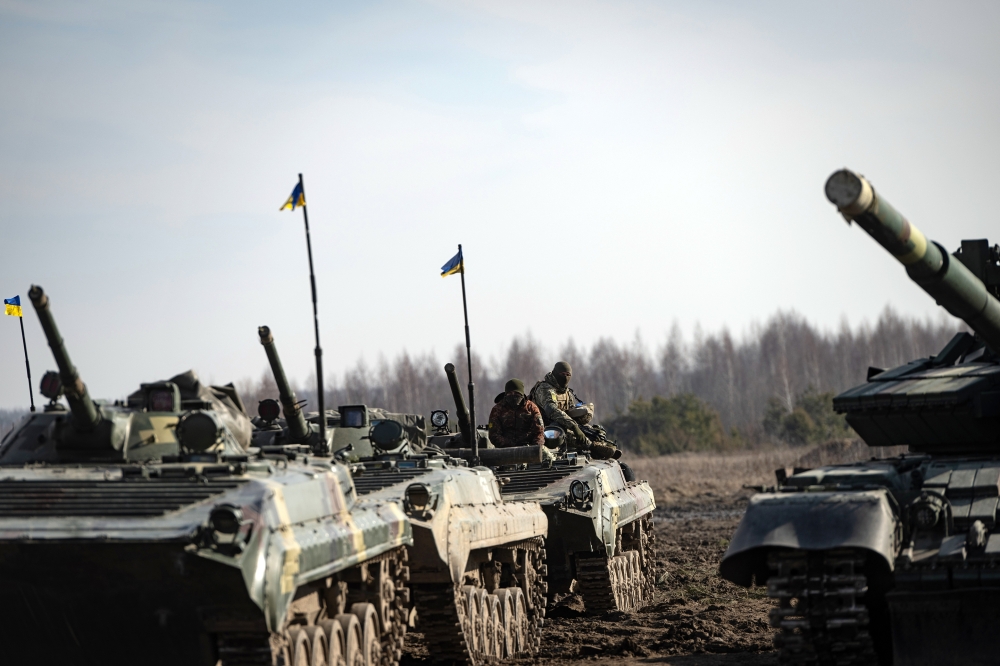 Ukrainian tank crews take a break during military exercises on Wednesday, Feb. 16, 2022 at a base near Rivne, about 60 miles from the Belarus border. (Lynsey Addario/The New York Times)