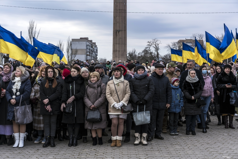 People gather for a ceremony to mark Unity Day in Kherson, Ukraine, on Wednesday, Feb. 16, 2022. (Brendan Hoffman/The New York Times)