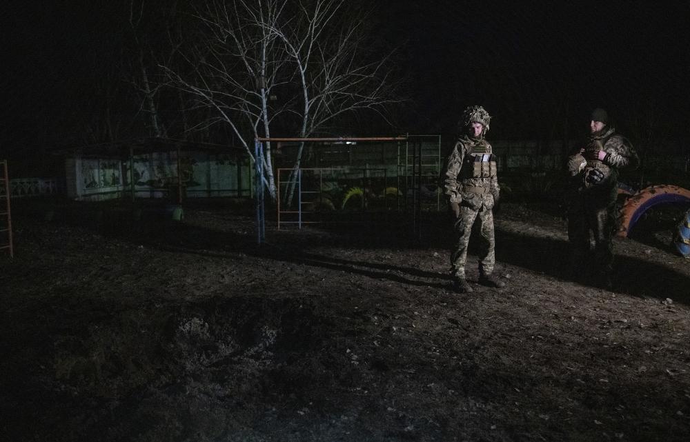 Ukrainian soldiers outside a kindergarten damaged by shelling in the town of Stanytsia Luhanska, Ukraine, Feb. 17, 2022.  (Lynsey Addario/The New York Times) 