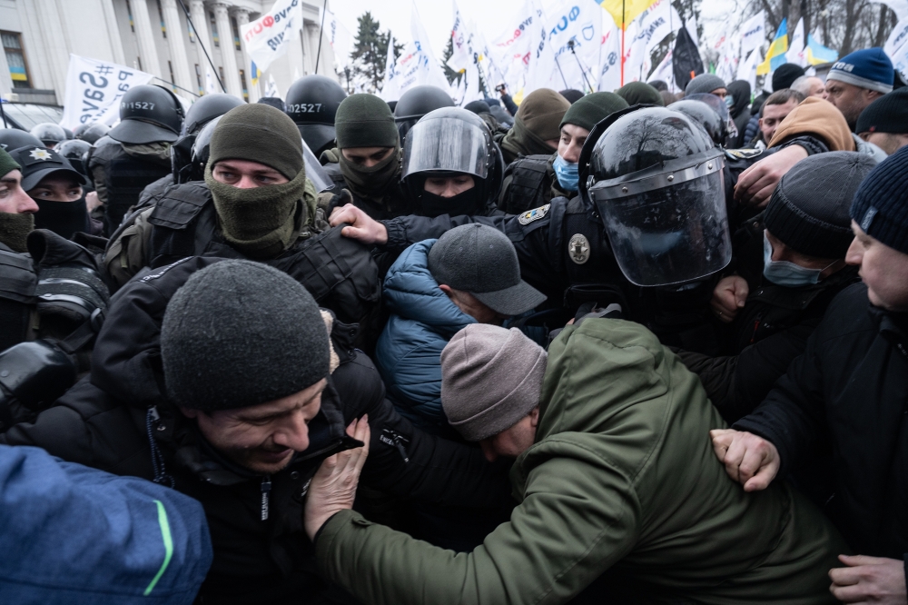 Supporters of the "save small business" movement clash with police outside the Ukrainian Parliament in Kyiv, Ukraine, Feb. 17, 2022.  (Lynsey Addario/The New York Times) 