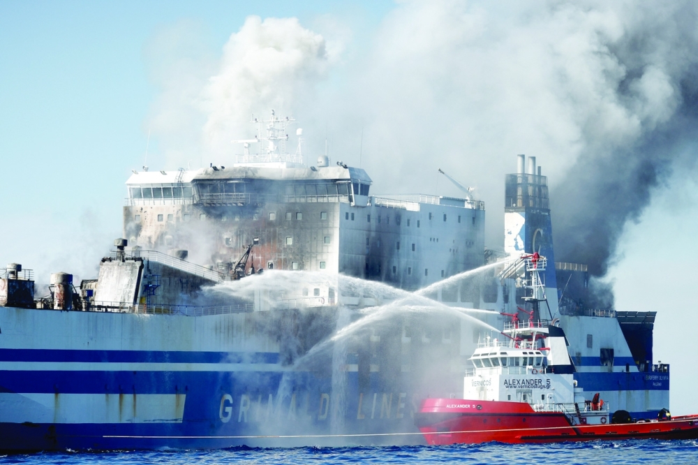 Smoke rises from the Italian-flagged Euroferry Olympia, which sailed from Greece to Italy early on Friday and caught fire, off the coast of Corfu, Greece, February 19, 2022. REUTERS/Guglielmo Mangiapane