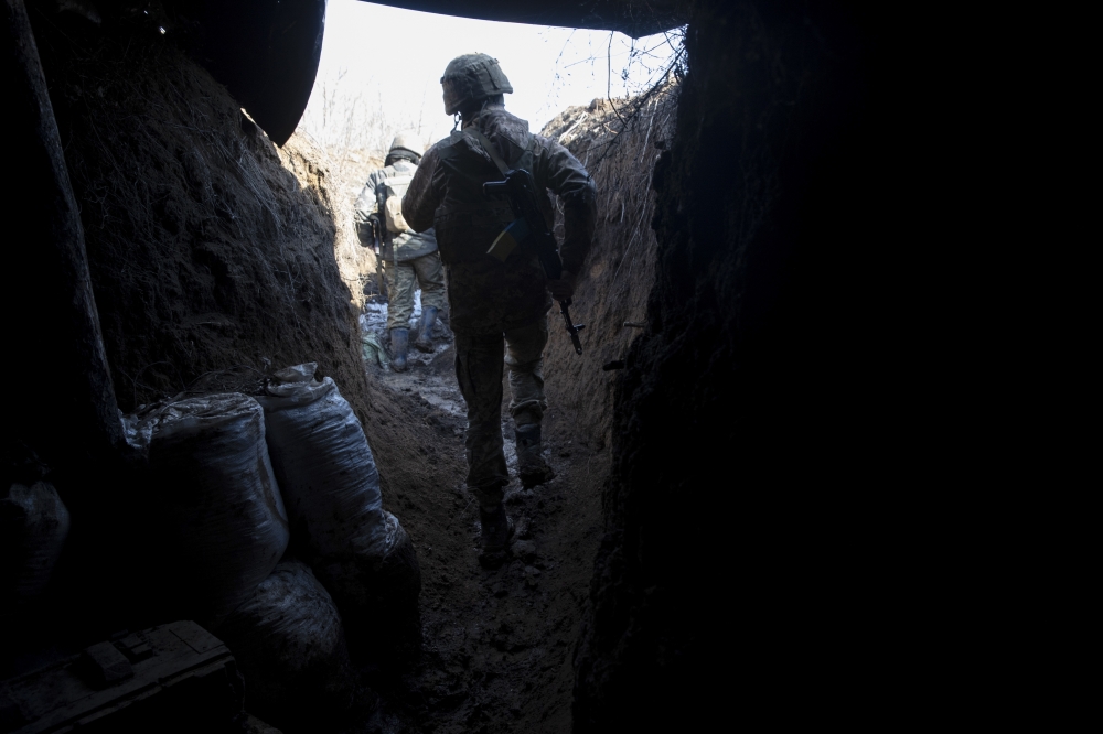 Ukrainian soldiers at a front line position, which has come under recent mortar attack, in Novozvanivka, Ukraine, Feb. 21, 2022. (Tyler Hicks/The New York Times)