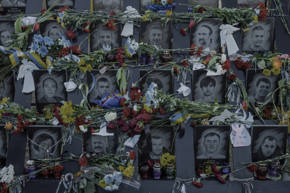 Portraits of the protesters gunned down by security forces in Ukraines capital, Kyiv, in February 2014, are seen at the "Heavenly Hundred New Martyrs Shrine in Kyiv, Feb. 20, 2022. (Emile Ducke/The New York Times)