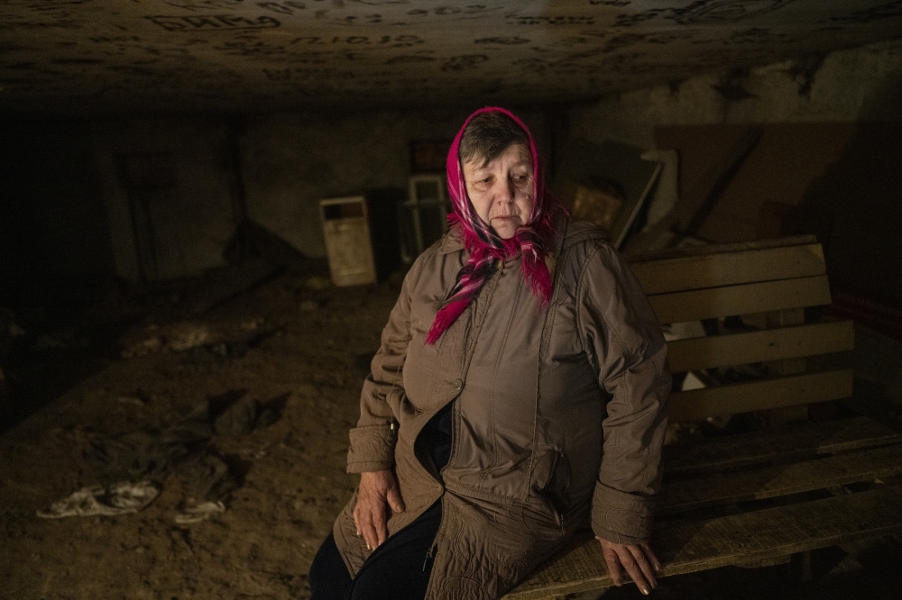 Ukrainians in a shelter beneath a residential building after hearing that separatists had returned to their artillery positions in the village of Vrubivka, Ukraine, Feb. 21, 2022. (Lynsey Addario/The New York Times)