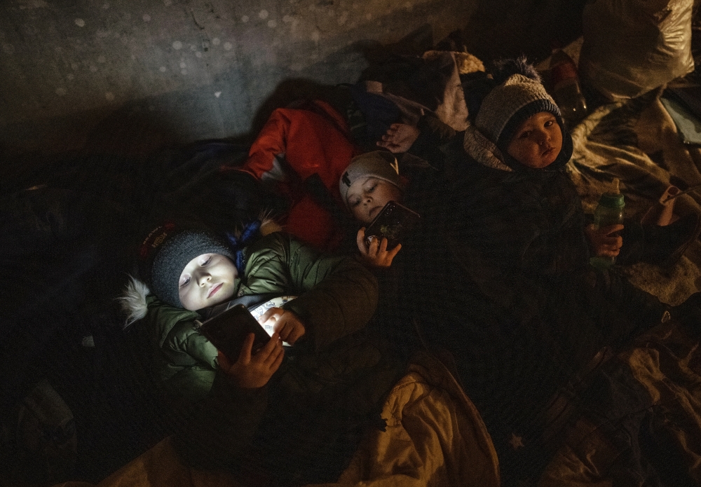 Children in a shelter beneath a residential building after hearing that separatists had returned to their artillery positions in the village of Vrubivka, Ukraine, Feb. 21, 2022. (Lynsey Addario/The New York Times)