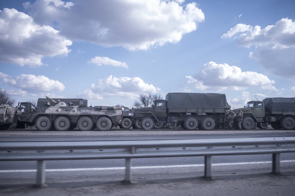 A column of Russian trucks and armored vehicles on a highway in the vicinity of Rostov-on-Don, Russia, about 60 miles from the border with Ukraine, Feb. 21, 2022.  (Sergey Ponomarev/The New York Times)