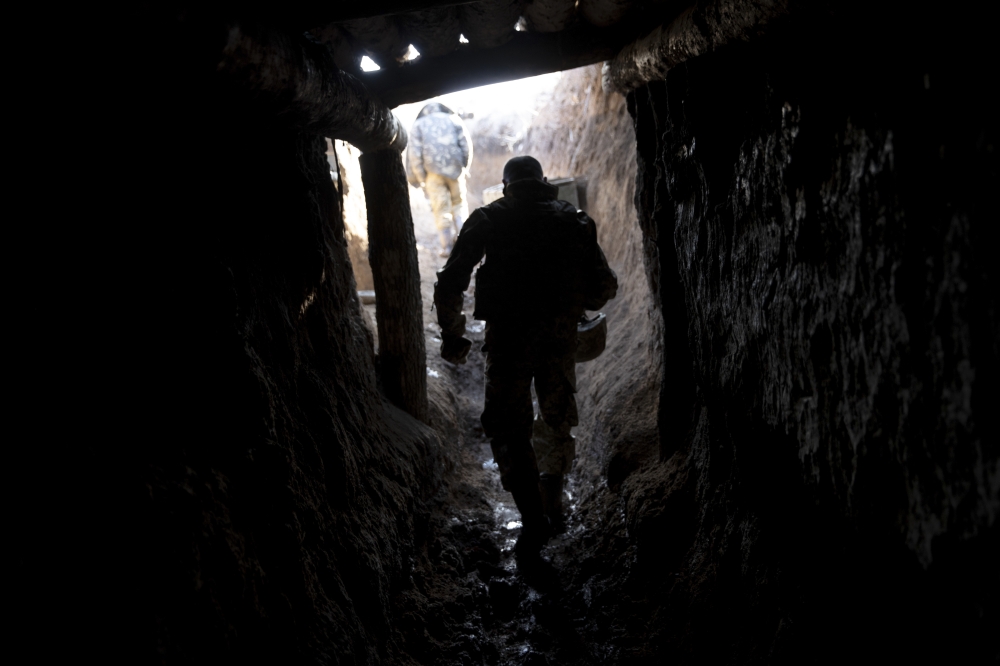 Ukrainian soldiers at a front line position, which has come under recent mortar attack, in Novozvanivka, Ukraine, Feb. 21, 2022. (Tyler Hicks/The New York Times)