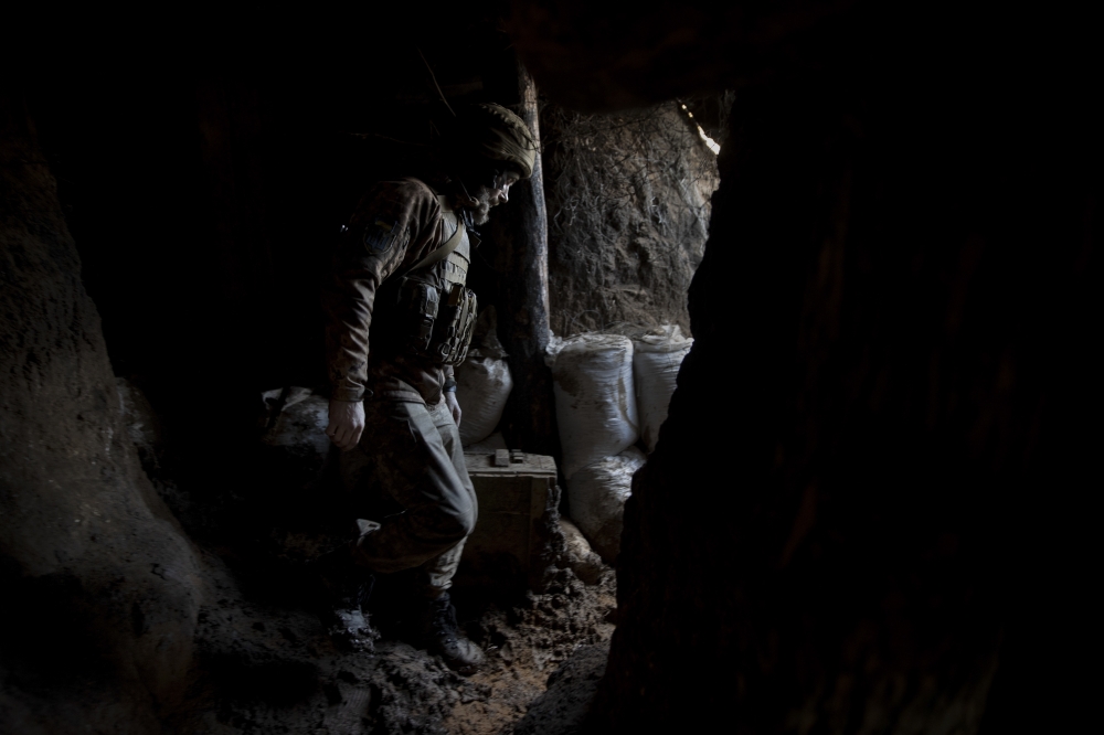 A Ukrainian soldier at a front line position, which has come under recent mortar attack, in Novozvanivka, Ukraine, Feb. 21, 2022. (Tyler Hicks/The New York Times)