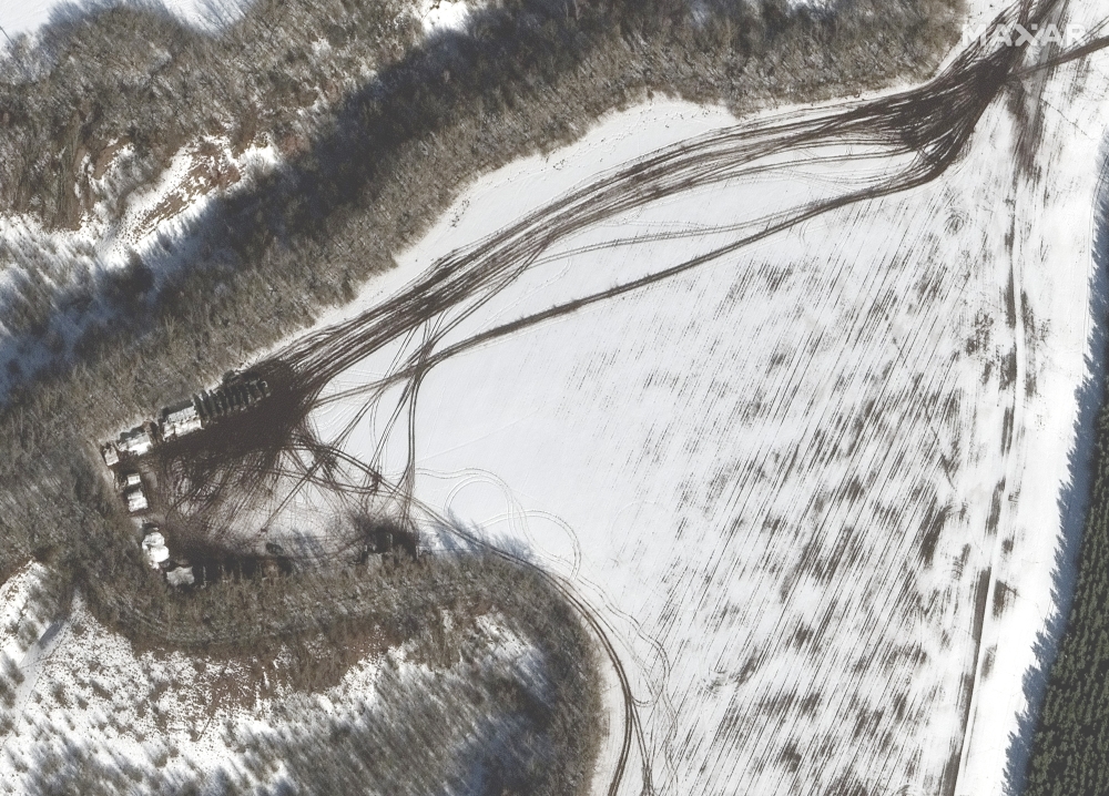 In a satellite image provided by Maxar Technologies, a small deployment of Russian troops along a tree line, approximately 20 miles from the Ukrainian border, near Belgorod, Russia, Sunday, Feb. 20, 2022. (Satellite image ©2022 Maxar Technologies via The New York Times)  