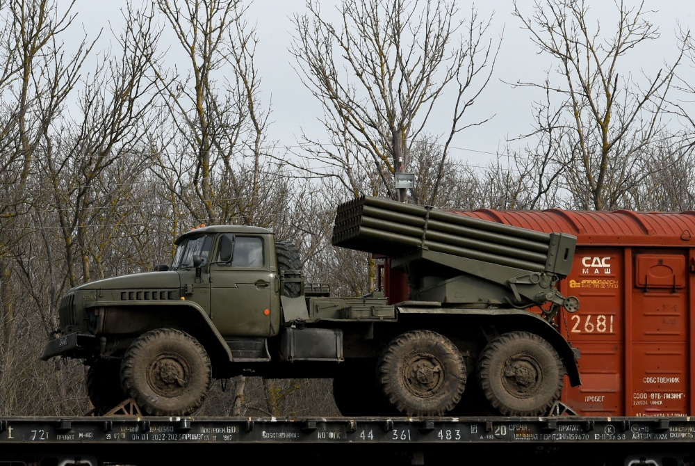 Russian military vehicles are seen loaded on train platforms some 50 km off the border