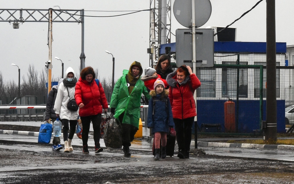 A group of people from separatist-controlled regions in eastern Ukraine crosses the border into Russia 