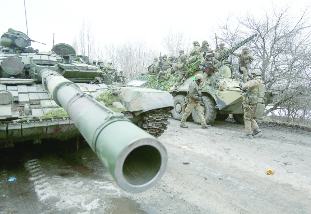 Ukrainian servicemen get ready to repel an attack in Ukraine's Lugansk region on Friday. - AFP