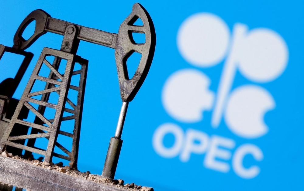 A 3D-printed oil pump jack is seen in front of displayed Opec logo in this illustration picture. — Reuters