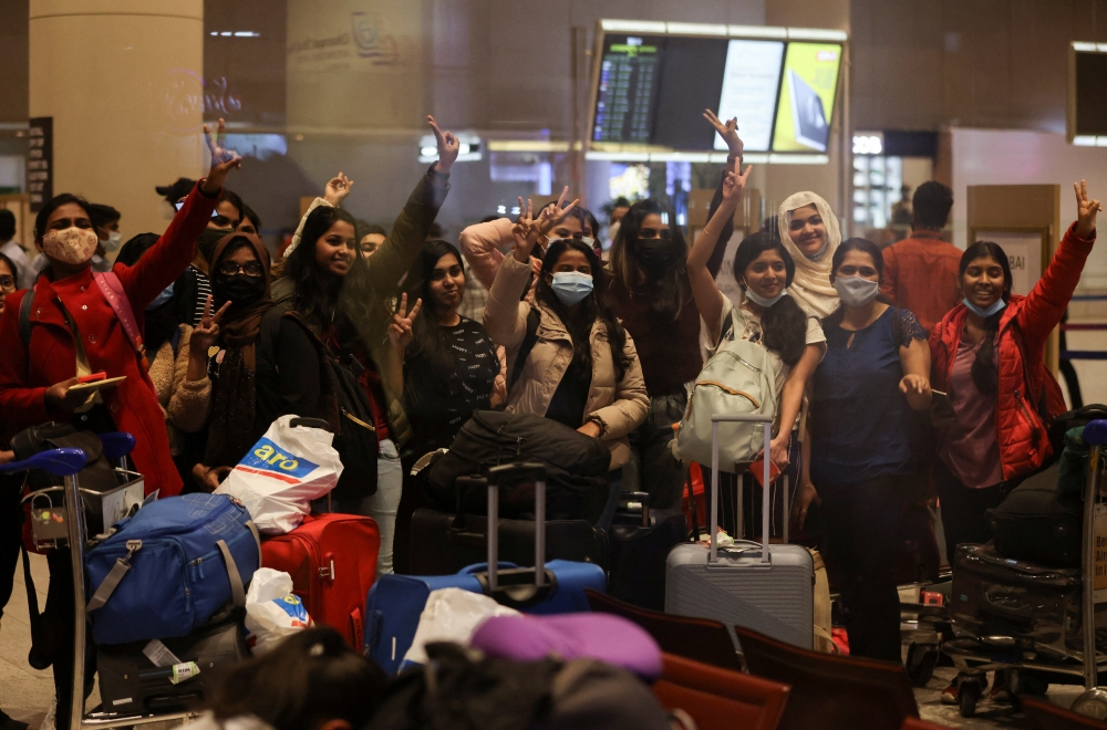 Students react after landing at the Chhatrapati Shivaji Maharaj International Airport after a special Air India flight carrying stranded Indian citizens from Ukraine landed in Mumbai
