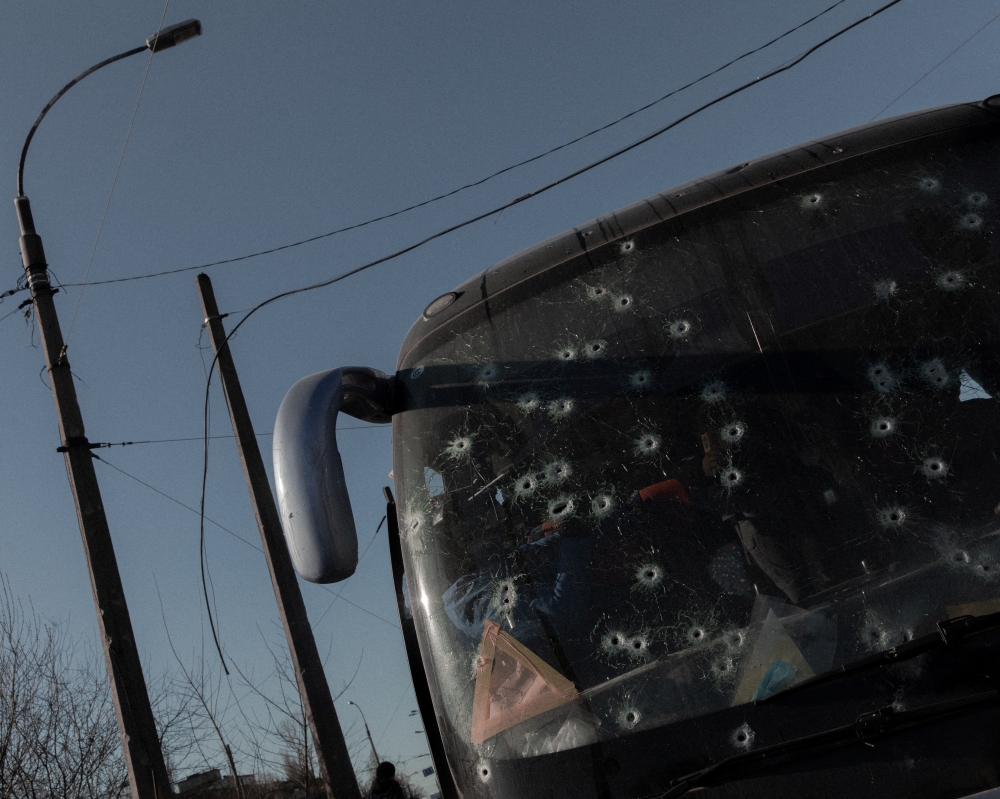 Bullet holes are pictured on the windscreen of a bus in Kyiv