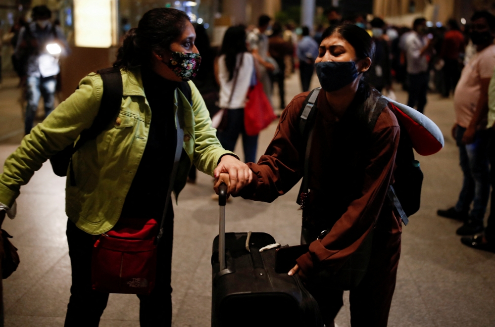 Students react as they leave the Chhatrapati Shivaji Maharaj International Airport after a special Air India flight carrying stranded Indian citizens from Ukraine landed in Mumbai