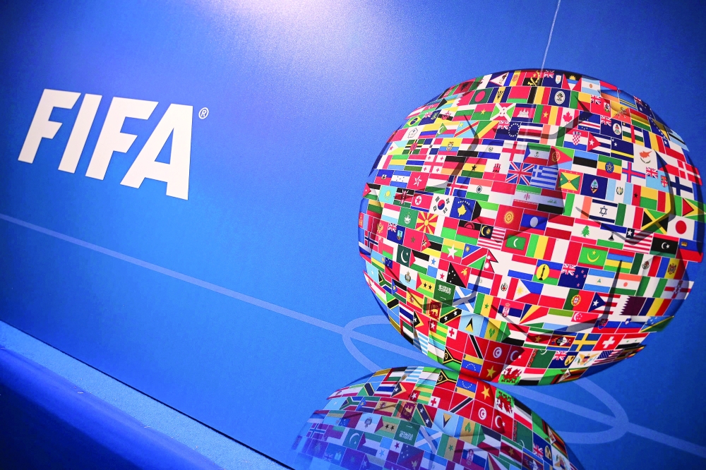 (FILES) This file photo taken on February 15, 2019 shows the FIFA logo during a press conference held by the president of the football's governing body at the FIFA Executive Football Summit in Istanbul. FIFA bans Russian national anthem and flag from international games announced official on February 27, 2022. (Photo by OZAN KOSE / AFP)

